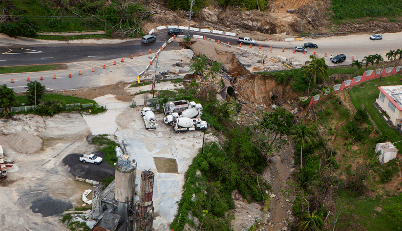 A mountain highway was washed out by the torrential rains Hurricane Maria brought. Damaged roads made currency distribution a complicated undertaking. Photo by Andrea Booher, courtesy of the Federal Emergency Management Agency