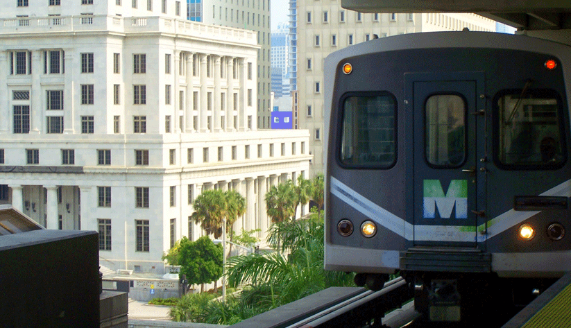 photograph of Metrorail train pulling into an elevated station