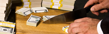 main cutting stacks of money with a knife